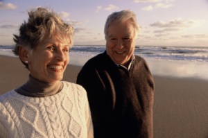 older couple walking on the beach